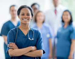 Nurse standing with arms crossed smiling to camera
